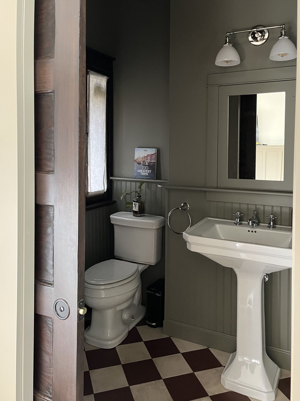 Craftsman ADU bathroom with pedestal sink and checkerboard tile floor